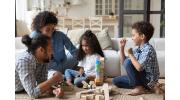 Black family playing with wooden blocks.