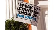 Yard Sign saying Speak up, stand up, show up for justice.