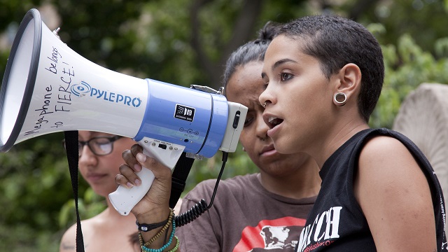 Youth advocate states her opinion through a megaphone